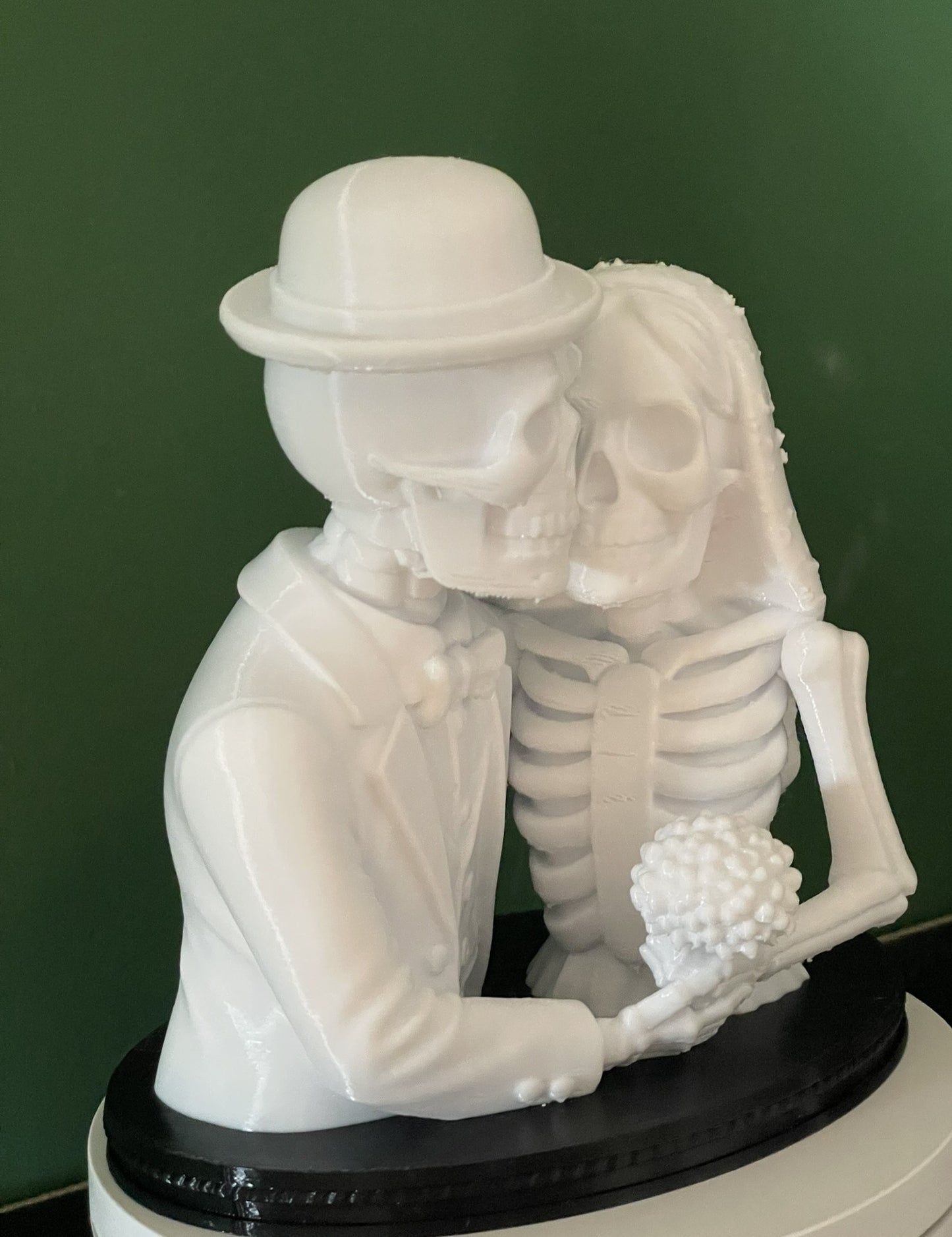Close-up of white 3D printed skeleton couple Halloween figurine