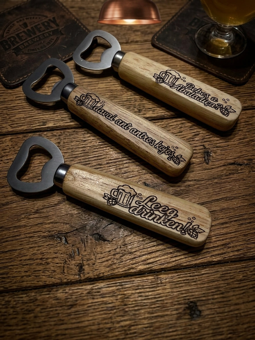 Three wooden bottle openers with metal bottle-cap-shaped heads are arranged on a rustic wooden table. Each handle is engraved with beer-themed text and a beer mug graphic.