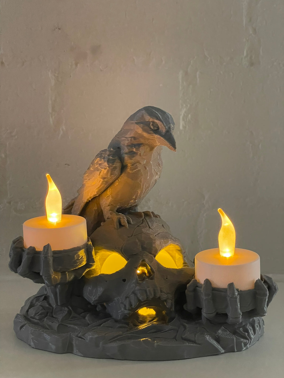 Halloween skull and raven LED candle holder with three glowing candles in a dark gothic design.