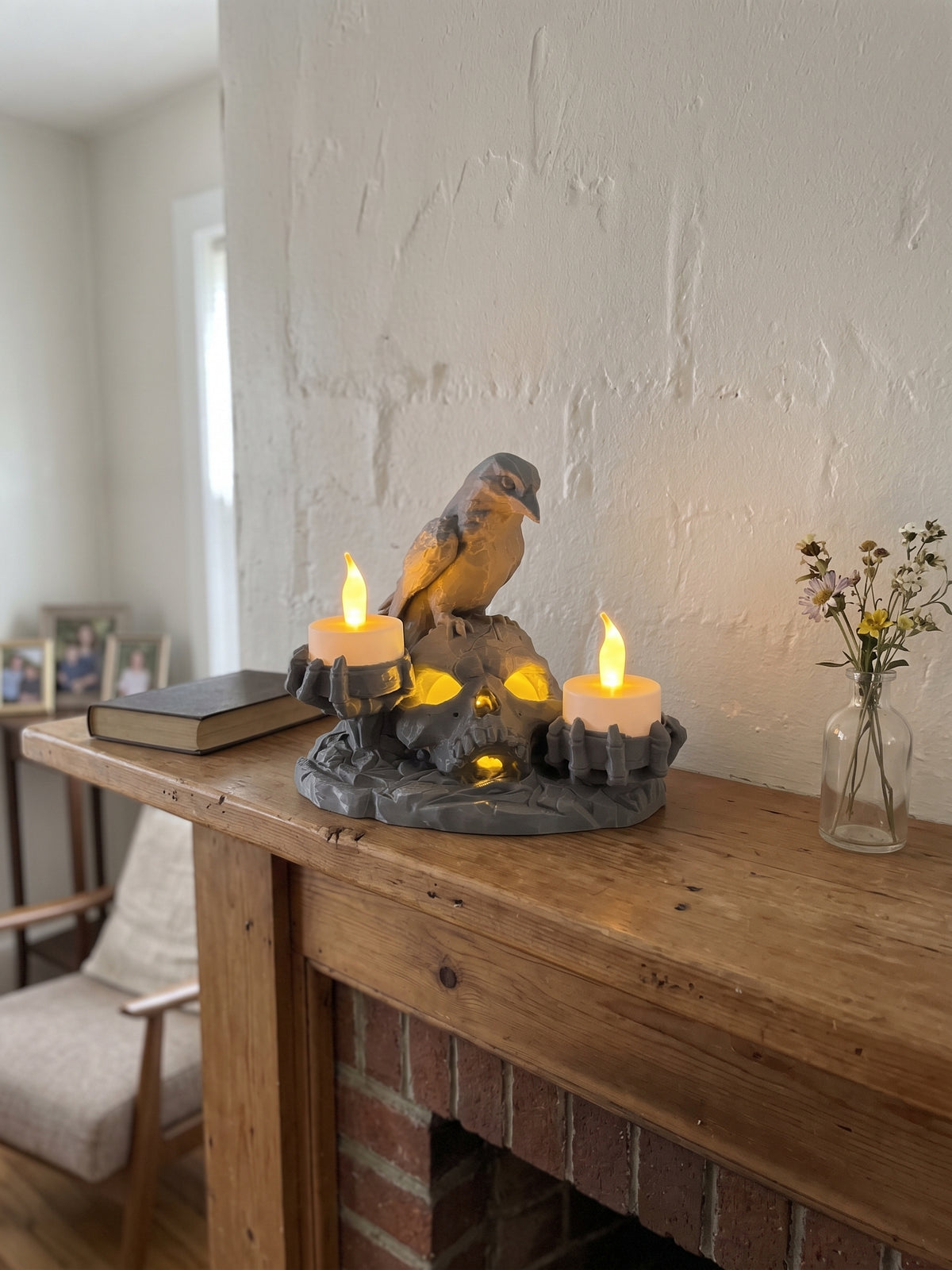 Halloween skull and raven candle holder with three glowing LED candles styled on a wooden console table.