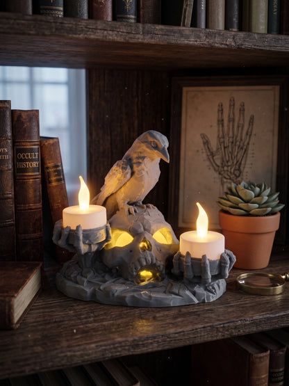 Gothic skull and raven LED candle holder displayed with books and Halloween home decor.